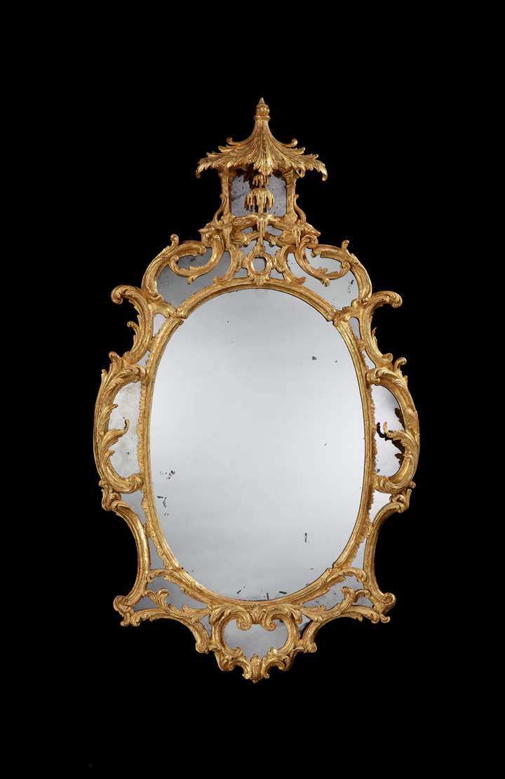 A GEORGE II GILTWOOD OVAL BORDER GLASS MIRROR